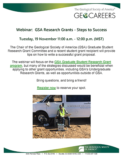 A geologist working outside on a laptop with scientific equipment smiles at the camera in front of a van.