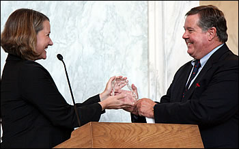 Kasey White presents the USGS Coalition Leadership Award to Rep. Ken Calvert (R-CA) for his support of hazard and other USGS research.