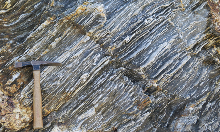 A sheeted vein complex with a rock hammer for scale.